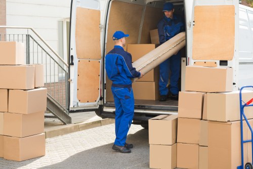 Furniture pick-up service removing a sofa in Southkensington