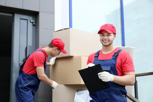 Professional piano movers handling a grand piano in South Kensington