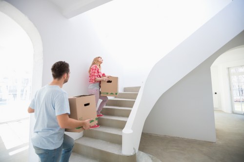 Removal team handling furniture in a South Kensington property with narrow access