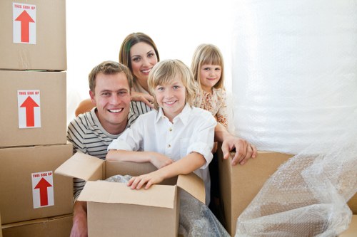 Movers carrying furniture carefully from a South Kensington home
